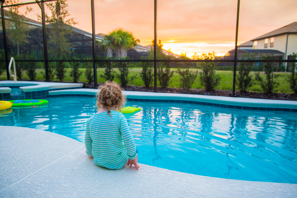 child sitting near pool unsupervised water safety